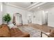 Spacious living room features a large mirror, a cozy brown sofa, and hard wood floors with modern lighting at 4237 E Sierra Madre Ave, Gilbert, AZ 85296