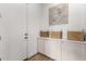 Bright mudroom features built in cabinets with woven baskets, white walls, and a light wood floor at 4237 E Sierra Madre Ave, Gilbert, AZ 85296