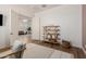 Bright and airy home office featuring wood floors, neutral tones, and a view into the living room at 4237 E Sierra Madre Ave, Gilbert, AZ 85296