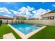 Backyard pool and spa with manicured green grass and privacy wall at 4237 E Sierra Madre Ave, Gilbert, AZ 85296