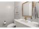 Elegant powder room featuring a modern vanity, decorative mirror, and stylish fixtures at 4237 E Sierra Madre Ave, Gilbert, AZ 85296