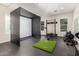 Spacious recreation room with golf simulator, weight rack, rubber flooring and bright lighting at 4237 E Sierra Madre Ave, Gilbert, AZ 85296