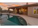 Charming outdoor area with a covered patio, sparkling pool, and well-manicured desert landscape at 4413 S Tigre Del Mar Dr, Gold Canyon, AZ 85118