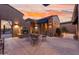 Inviting backyard patio featuring a fireplace, comfortable seating, and a view of the desert landscape at 4413 S Tigre Del Mar Dr, Gold Canyon, AZ 85118