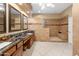 Luxurious bathroom featuring granite countertops, double sinks, and a spacious walk-in shower with decorative tile accents at 4413 S Tigre Del Mar Dr, Gold Canyon, AZ 85118