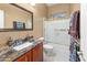 Bright bathroom with a shower over bath, granite counters, modern fixtures, and a large mirror at 4413 S Tigre Del Mar Dr, Gold Canyon, AZ 85118