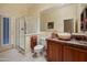 Well-appointed bathroom featuring a glass-enclosed shower, stylish vanity, and a door to the backyard at 4413 S Tigre Del Mar Dr, Gold Canyon, AZ 85118