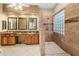 Elegant bathroom featuring dual vanities, decorative tile, and a glass block shower at 4413 S Tigre Del Mar Dr, Gold Canyon, AZ 85118