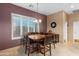 Casual dining area with large shuttered window, tile floors, and stylish light fixture at 4413 S Tigre Del Mar Dr, Gold Canyon, AZ 85118