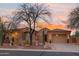 Beautiful home exterior with desert landscaping, mature trees, and a spacious two-car garage at 4413 S Tigre Del Mar Dr, Gold Canyon, AZ 85118
