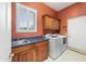 Functional laundry room with a sink, cabinets, and modern washer and dryer for convenient chores at 4413 S Tigre Del Mar Dr, Gold Canyon, AZ 85118
