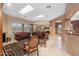 Bright living room with tile floors, skylights, comfortable seating, and a fireplace at 4413 S Tigre Del Mar Dr, Gold Canyon, AZ 85118