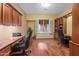 Bright home office boasts custom built-ins, hardwood floors, and ample natural light at 4413 S Tigre Del Mar Dr, Gold Canyon, AZ 85118
