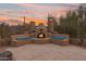 Inviting outdoor fireplace with built-in seating, perfect for entertaining and enjoying evenings outdoors at 4413 S Tigre Del Mar Dr, Gold Canyon, AZ 85118