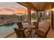 Inviting covered patio with comfortable seating and serene views of the lush backyard and sparkling pool at 4413 S Tigre Del Mar Dr, Gold Canyon, AZ 85118