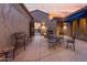 Comfortable outdoor patio seating area with outdoor fireplace and desert views at 4413 S Tigre Del Mar Dr, Gold Canyon, AZ 85118