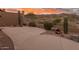 Spacious patio area with desert landscaping, native plants, and charming accents for outdoor living at 4413 S Tigre Del Mar Dr, Gold Canyon, AZ 85118