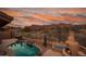 Inviting backyard pool with desert landscaping, outdoor fireplace, and mountain views at 4413 S Tigre Del Mar Dr, Gold Canyon, AZ 85118