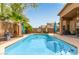 Private backyard oasis features a sparkling pool with mature landscaping, patio seating, and bbq at 4630 E Mountain Vista Dr, Phoenix, AZ 85048