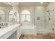 Bright bathroom with double sinks, vanity space, separate tub, and walk-in shower at 4630 E Mountain Vista Dr, Phoenix, AZ 85048
