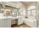 Bright bathroom with double sinks, vanity space, separate tub, and walk-in shower at 4630 E Mountain Vista Dr, Phoenix, AZ 85048