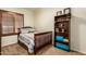 Cozy bedroom features a twin bed, wood shutters, and dark wood bookshelf for ample storage at 4630 E Mountain Vista Dr, Phoenix, AZ 85048