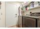 Functional laundry room with a front loading washer and dryer, and ample shelving at 4630 E Mountain Vista Dr, Phoenix, AZ 85048