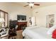 Bedroom with a fireplace, TV, desk, and access to an ensuite bathroom at 4630 E Mountain Vista Dr, Phoenix, AZ 85048
