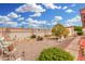Scenic backyard with multiple seating arrangements and flowering trees and bushes at 4838 E Calypso Ave, Mesa, AZ 85206