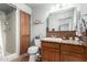 Updated bathroom featuring tiled shower and granite counters on the wood vanity at 4838 E Calypso Ave, Mesa, AZ 85206