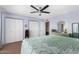 Bright bedroom features a ceiling fan, closet space, and neutral walls at 4838 E Calypso Ave, Mesa, AZ 85206
