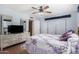 Secondary bedroom featuring ceiling fan, closet, and adjacent ensuite bathroom at 4838 E Calypso Ave, Mesa, AZ 85206