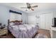 Cozy bedroom with purple accents featuring ceiling fan and closet at 4838 E Calypso Ave, Mesa, AZ 85206