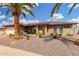 Charming brick home featuring desert landscaping, a paved driveway, and a prominent palm tree in the front yard at 4838 E Calypso Ave, Mesa, AZ 85206