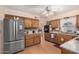 Open kitchen featuring granite countertops, wood cabinets, and stainless steel appliances at 4838 E Calypso Ave, Mesa, AZ 85206