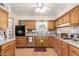 Charming kitchen features wood cabinets, granite countertops, and modern stainless steel appliances at 4838 E Calypso Ave, Mesa, AZ 85206