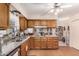 Eat-in kitchen featuring granite counters and wood cabinets; view to the Gathering room at 4838 E Calypso Ave, Mesa, AZ 85206
