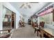 Sun-lit living room with neutral carpet, ceiling fans, and multiple seating areas at 4838 E Calypso Ave, Mesa, AZ 85206