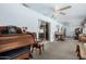 Living room featuring neutral carpet, ceiling fans, and plenty of room for furniture at 4838 E Calypso Ave, Mesa, AZ 85206
