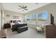 This bedroom features generous natural light from many windows, complemented by a modern ceiling fan at 5195 N 207Th Dr, Buckeye, AZ 85396