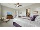 Cozy bedroom featuring plush carpeting, a ceiling fan, and a TV for relaxed, private viewing at 5195 N 207Th Dr, Buckeye, AZ 85396