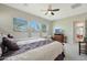 This spacious bedroom includes a ceiling fan and multiple windows with pleasing views and bright natural light at 5195 N 207Th Dr, Buckeye, AZ 85396