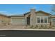 Charming single-story home with a brick chimney, attached garage, and well-manicured landscaping for curb appeal at 5195 N 207Th Dr, Buckeye, AZ 85396