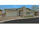 Charming single-story home featuring a two-car garage and a meticulously landscaped front yard at 5195 N 207Th Dr, Buckeye, AZ 85396