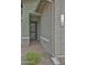 Inviting front porch with brick accents, modern house numbers and charming landscaping at 5195 N 207Th Dr, Buckeye, AZ 85396