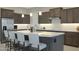 Modern kitchen with a large island, stainless steel appliances, and stylish pendant lighting at 5195 N 207Th Dr, Buckeye, AZ 85396