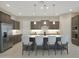 Modern kitchen featuring dark wood cabinetry, a center island with seating, and recessed lighting at 5195 N 207Th Dr, Buckeye, AZ 85396