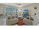 Comfortable living room with plush seating, a ceiling fan, and a sliding glass door at 5195 N 207Th Dr, Buckeye, AZ 85396
