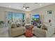 Comfortable living room with plush seating, a ceiling fan, and a sliding glass door at 5195 N 207Th Dr, Buckeye, AZ 85396