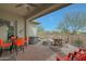 Relaxing outdoor patio with a hot tub, a fire pit, cozy seating, and a mounted television for easy viewing at 5195 N 207Th Dr, Buckeye, AZ 85396